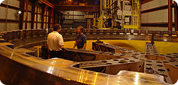 Tari inspecting the machining on our 25 foot diameter forged ring Tari inspecting the machining on our 25 foot diameter forged ring